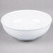 A white Thunder Group melamine pho noodle bowl with a white rim on a gray surface.