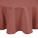 A mauve Intedge round tablecloth with a white hem on a table.