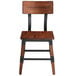 A Lancaster Table & Seating rustic industrial dining side chair with a wooden seat and back and metal legs.