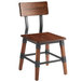 A Lancaster Table & Seating rustic wooden dining chair with black metal legs.