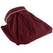 A burgundy table skirt with a white border.