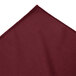 A burgundy Snap Drape table skirt with bow tie pleats.