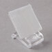 A clear plastic holder with white square Velcro clips.