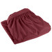 A burgundy Snap Drape table skirt with shirred pleats and Velcro clips.