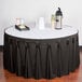 A table with a white top and a charcoal Snap Drape table skirt with Velcro clips.