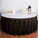 A table with a charcoal Snap Drape table skirt with Velcro clips.