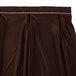 A brown Snap Drape table skirt with white bow tie pleats.