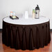 A table with a brown Snap Drape table skirt with Velcro clips on it.