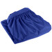 A royal blue Snap Drape table skirt folded on a white background.
