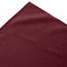 A burgundy Snap Drape box pleat table skirt.