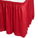 A red Snap Drape table skirt with Velcro clips on a white table.