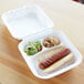 A white Eco-Products compostable 3-compartment takeout container with a hot dog and salad.