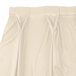 A white Snap Drape Wyndham table skirt with a pleated bow tie pattern.