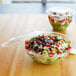 A salad in a clear Eco-Products plastic bowl with a lid.