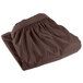 A brown table skirt with shirred pleats and a folded edge.