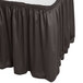 A charcoal Snap Drape table skirt with Velcro clips on a table with a white surface.