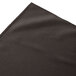 A charcoal Snap Drape table skirt with a folded edge.