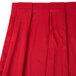 A red Snap Drape table skirt with pleats.