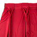 A red Snap Drape pleated table skirt with bow tie pleats.
