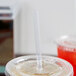 A plastic cup of ice tea with a clear wrapped Eco-Products compostable plastic straw in it.
