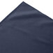 A folded navy blue Snap Drape table skirt with a box pleat design.