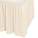 A bone Snap Drape shirred pleat table skirt with a ruffled edge.