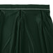 A jade green table skirt with a white pleated band with Velcro clips.