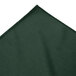A close-up of a green fabric with an edge.