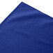 A royal blue Snap Drape shirred pleat table skirt on a table.