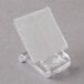 A clear plastic holder with a white square sitting on a stand.