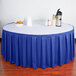 A table with a royal blue Snap Drape box pleat table skirt.