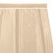 A cream Snap Drape box pleat table skirt with a white border.