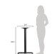A woman standing next to a BFM Seating stamped steel counter height table base.