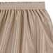 A beige Snap Drape table skirt with shirred pleats on the side.