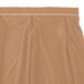 A tan Snap Drape Wyndham table skirt with a brown and white stripe and velcro clips.