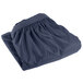 A folded navy blue Snap Drape table skirt with velcro clips.