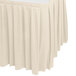 A bone box pleat table skirt with Velcro clips on a white table.