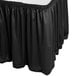 A black Snap Drape Wyndham table skirt with pleats and velcro clips.
