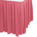 A dusty rose Snap Drape box pleat table skirt on a white table.