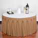 A table with a Snap Drape Sandalwood table skirt on a white table with a tray of cups and a thermos.