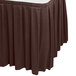 A brown box pleat table skirt with velcro clips on a table.