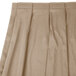 A beige box pleat table skirt with velcro clips.