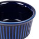 A blue china fluted ramekin with a stripe pattern.