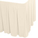 A white table skirt with pleated edges.