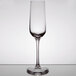 A clear Stolzle Revolution wine flute on a table.