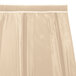 A cream Snap Drape box pleat table skirt with a white trim.