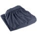 A navy blue shirred pleat table skirt folded on a white background.