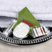 A white towel with a Basic Earth Botanicals toothbrush and toothbrush holder on a tray.
