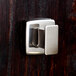 A close-up of a Bobrick bright polished metal robe hook.