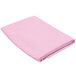 A pink folded cloth on a white background.